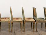 four chairs that are sitting in a row on the floor