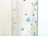 a glass vase with a flower design on it