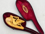 a small wooden spoon with a figurine inside of it