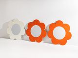 three mirrors that are sitting on a white surface
