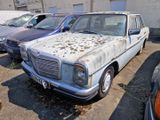 many old cars parked in a parking lot