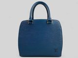 a blue louis vuitton bag on a white background