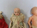three dolls that are sitting next to each other on a table