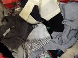 a pile of clothes that is sitting in a suitcase