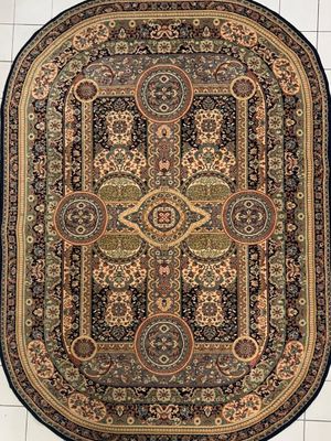 TAPIS de forme ovale en laine.