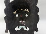 an image of a wooden mask with a face on it ' s face