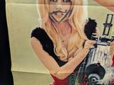 a poster of a woman holding a machine gun