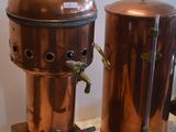 two copper pots sitting on top of a marble counter
