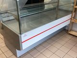 a glass display case with a laptop on top of it