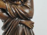 bronze statue of a woman holding a baby in her arms