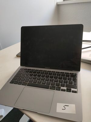 a laptop computer sitting on top of a wooden desk