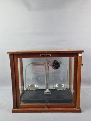 a glass display case with a clock inside of it