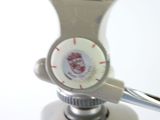 a close up of a faucet with a red and white knob