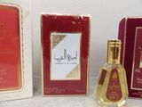 two boxes of perfume sitting next to each other on a table