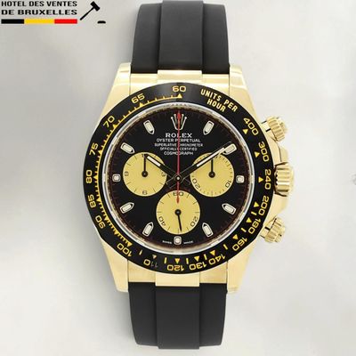 the watch is black and gold with a yellow dial