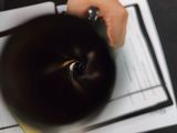 a person holding a cup of coffee on top of a table