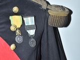 a man in a uniform with medals on his shoulder