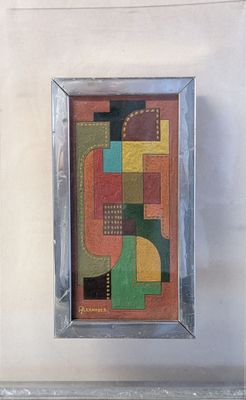painting of abstract shapes in a silver frame hanging on a wall