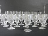 a lot of wine glasses and a decanter on the table