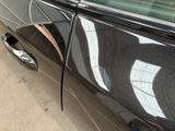 a black car parked on the side of the street