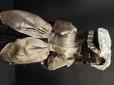 a doll that is wearing a dress and a hat