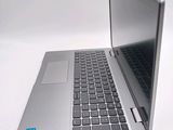 a silver laptop with a blue sticker on the screen