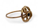 a close up of a gold ring with a black stone in it