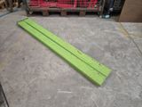 a green piece of wood laying on the floor