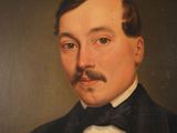 portrait of a man in a tuxedo with a mustache and moustache