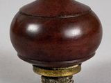 a small wooden object on a white surface