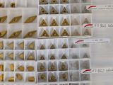 a lot of different types of metal parts in a box