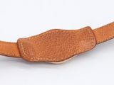 brown leather belt on a white surface with a white background