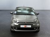 the small car is parked in a large room with a black floor
