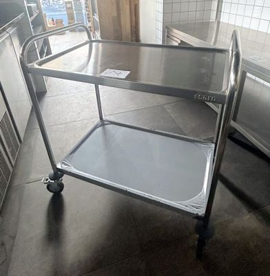 a stainless steel cart in the middle of a kitchen