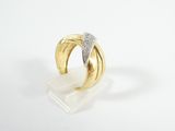 a close up of a gold and diamond ring on a white surface