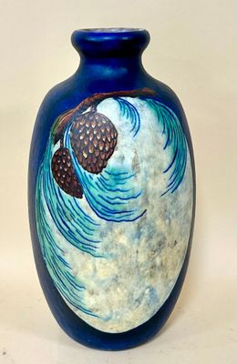 a blue vase with a picture of a pine on it
