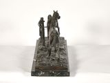 bronze statue of a horse and rider on a stone base
