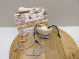a small purse and a necklace on a wooden table