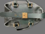a green purse with a gold lock on it