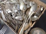 a box full of silver spoons and spoons on a table