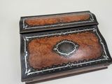 a small wooden box with a decorative design on it
