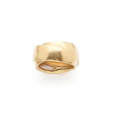 a close up of a gold ring on a white background