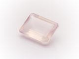 a pink quartz stone on a white background