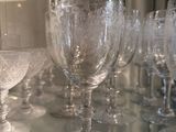 many wine glasses sitting on a glass table