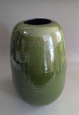 a green vase that is sitting on a table
