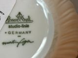 a white plate with a tag on it with a name tag on it