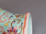 a blue vase with flowers on it on a table