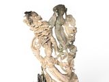 statue of a woman holding a bird on a wooden base