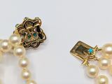a pearl necklace with a gold clasp and a pearl necklace with a gold clasp