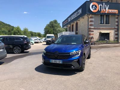 the blue car is parked in front of a building on the side of the road